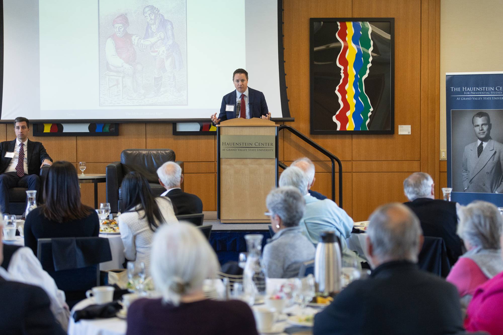 person speaking at a podium